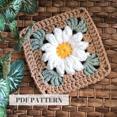 a crocheted square with a flower on it