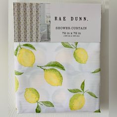 the fabric has lemons on it and is white with green leaves, which are also yellow