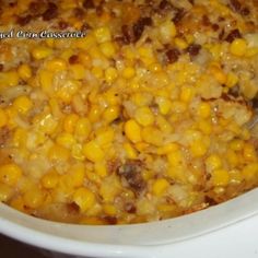 a white crock pot filled with corn and meat