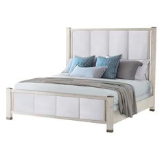 a white bed with blue and gray pillows on it's headboard, in front of a white background