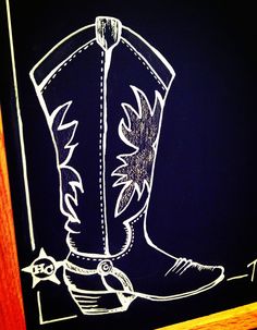 a drawing of a cowboy boot on a blackboard