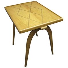 a small wooden table with an interesting design on it's top and bottom edge