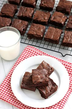 chocolate brownies on a plate next to a glass of milk