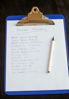 a clipboard with a pen on top of it next to a piece of paper that says freezer inventory