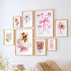 a living room filled with lots of framed pictures on the wall above a white couch