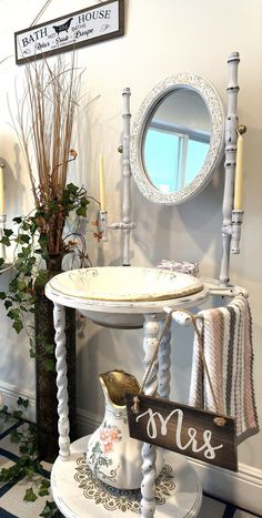 a white table with candles, mirror and other items on it in a room that has blue and white checkered flooring