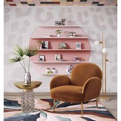 a living room with pink shelving and gold accents