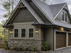 a large house with two garages in front of it