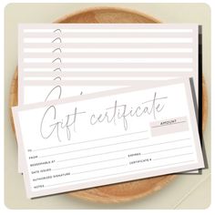 a gift certificate sitting on top of a wooden plate