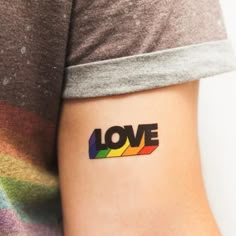 a person with a tattoo on their arm that says love in the middle of it