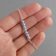 "This powder blue pearl bracelet is finished with Sterling silver chain and features a bar of light blue Swarovski pearls. These pale blue pearl bracelets make the ideal bridal party gift for bridesmaids or a \"something blue\" gift for a bride. With the exception of the 1 inch silver plated extender chain, which allow you to adjust your bracelet to fit, all of the metal elements are Sterling silver. Each minimal layering bracelet measures 7 inches / 18cm in length and is finished with a bolt ring clasp. Your pastel blue jewellery will arrive gift wrapped and ready to present as a gift or a treat to yourself. All of my items are securely packaged to ensure their safe arrival. --------------------- Matching items available --------------------- Long powder blue pearl earrings: https://www.e Baby Blue Jewelry, Blue Pearl Bracelet, Chunky Stone Necklace, Blue Pearl Earrings, Blue Wedding Jewelry, Fused Glass Necklace, Light Blue Wedding, Crystal Jewelry Sets, Bleu Pastel