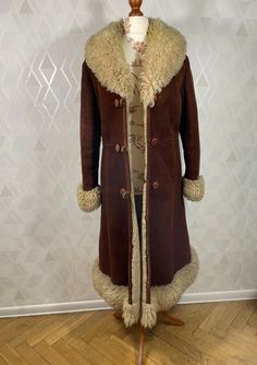 A unique dubble breasted coat made of thick sheepskin and neat thick leather in a dark brown color with a beige finish. This iconic Penny Lane coat is in very good condition, with normal sings of use, no damage, but remember that it is a wearable item. The coat is probably in size M, there is no tag. Dimensions: sleeve from the collar: 76 cm sleeve from armpit: 41 cm chest:49 x2 cm waist: 46 x 2 cm in the hips: 51 x2 cm total length: 114 cm In the territory of the European Union, we send parcels Bohemian Leather Outerwear For Winter, Bohemian Leather Winter Outerwear, Bohemian Brown Outerwear With Faux Fur Lining, Bohemian Long Fur Coat With Faux Fur Trim, Famous Hippies, Vintage Long Coat With Faux Fur Lining, Fitted Brown Sheepskin Fur Coat, Bohemian Brown Fur Coat With Faux Fur Lining, Vintage Winter Coat