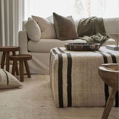 a living room filled with furniture and pillows