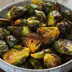 brussel sprouts in a white bowl on a wooden table