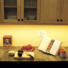 an open book sitting on top of a kitchen counter