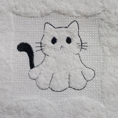 a white towel with a black cat on it