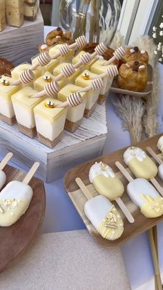 desserts and pastries are displayed on wooden trays