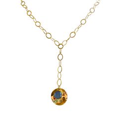 This stunning necklace showcases the captivating beauty of a blue sodalite gemstone layered over a gold circular pendant, elegantly dangling from a 2-inch lariat chain. The combination of the rich blue sodalite and the lustrous gold creates a striking contrast, resulting in a unique and eye-catching design. The blue sodalite gemstone is known for its deep and intense blue color, reminiscent of the serene ocean or the vast night sky. Its natural patterns and variations make each stone truly one-o Gold Gemstone Lariat Necklace With Long Drop, Elegant Blue Brass Necklace, Blue Gold-plated Chain Necklace With Adjustable Chain, Blue Adjustable Gold-plated Chain Necklace, Elegant Blue Lariat Necklace With Adjustable Chain, Blue Adjustable Gold Plated Chain Necklace, Gold Lariat Necklace With Round Pendant, Blue Hammered Dangle Jewelry, Blue Lariat Jewelry With Adjustable Chain