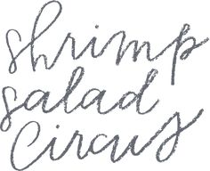 some type of handwriting that is written in black and grey ink with the words shrimp salad circus