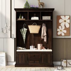 a wooden cabinet with an umbrella and other items on it in a living room area