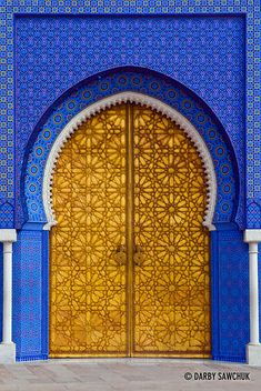 an ornate blue and yellow door with intricate designs