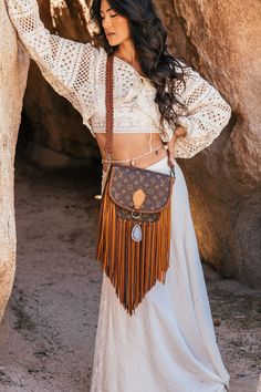 Compact, versatile and cleverly designed with an exterior easy access pocket, the World Traveler is an ideal go-everywhere bag. This messenger-style look is lightweight and roomy yet emanates effortless boho-chic. Dimensions: Medium: Width: 7"x Height: 7" Depth: 2.25"Large: Width: 9.5"x Height: 9.5" Depth: 3"Fringe Length: 12" Strap Options Option 1: Braided Adjustable crossbody strap from 30" to 57"Option 2: Adjustable crossbody & 19" Shorty round braided strap ***charm and beads pictured are i Bohemian Crossbody Bag With Strap, Bohemian Everyday Bag With Strap, Bohemian Shoulder Bag With Long Strap For Travel, Bohemian Shoulder Bag With Detachable Strap For Travel, Bohemian Shoulder Bag With Long Strap, Bohemian Shoulder Bag With Long Strap For Everyday Use, Bohemian Crossbody Bag, Everyday Bohemian Bag With Strap, Bohemian Everyday Bag