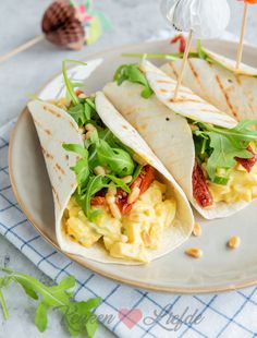 two tortillas with eggs and spinach on a plate