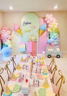 an ice cream themed birthday party with balloons and desserts on the tables in front of it