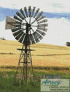 a windmill sitting in the middle of a field