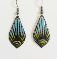 "These copper enameled earrings are done in shades of saphire blue and chartreuse over black. A sun burst pattern is etched into the enamel before firing. They are a 1 \" long drop shaped copper. These earrings are custom made with each order and I hand fired with a torch. Because they are hand made each time the end result can vary slightly. These earrings can be custom made to order - just send me an email with the colors you would like and what kind or earwire - copper, gunmetal or surgical s Retro Blue Drop Earrings Jewelry, Multicolor Enamel Jewelry With Ear Wire, Retro Green Enamel Jewelry, Artistic Black Enamel Jewelry, Green Teardrop Enamel Jewelry, Nickel-free Enamel Retro Jewelry, Blue And Chartreuse, Beachy Earrings, Sun Burst