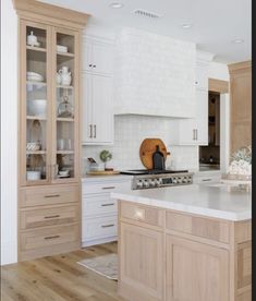 a kitchen with wooden cabinets and white counter tops, along with an island in the middle