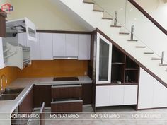 an empty kitchen with stairs leading up to the second floor