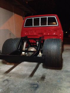 an off - road vehicle is parked in a garage with its front bumper lifted up