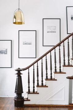 the stairs in this house have been decorated with pictures and framed on the wall above them