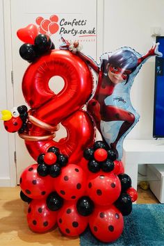 ladybug balloon sculpture in the shape of a number eight with balloons attached to it