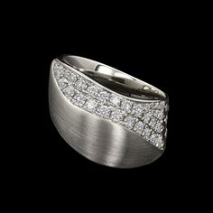 a wedding band with diamonds on it in white gold and diamond set into the center