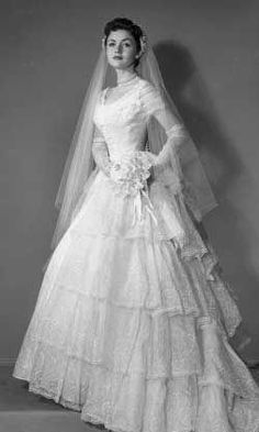 an old photo of a woman in a wedding dress