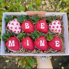 a box filled with chocolate covered strawberries and the words be mine written on them