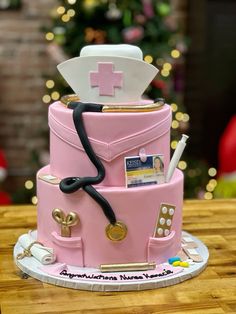 a pink cake with medical equipment on top