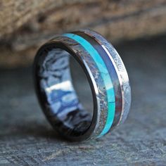 a wedding ring with blue and black inlays