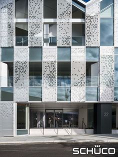 an architecturally designed building with white and black tiles on the facade is shown in this image