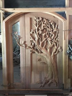 a wooden door with a tree carved into it