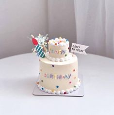 a birthday cake sitting on top of a white table