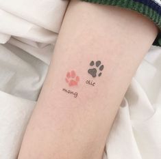 a person with a dog paw tattoo on their left arm and the words, bite moving