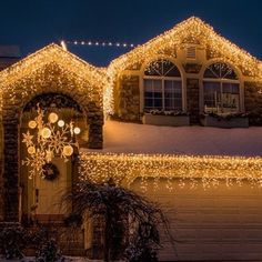 a house covered in christmas lights at night