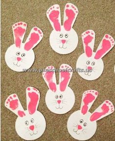 some pink and white paper cut outs with bunny ears on top of each other in the shape of rabbits