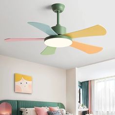 a bedroom with a green headboard and ceiling fan in the middle of it's room