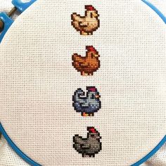 a cross stitch pattern with chickens and roosters on it's side, in blue hoop