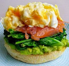 a sandwich with eggs, bacon and lettuce on it