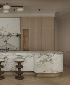 a kitchen with marble counter tops and stools